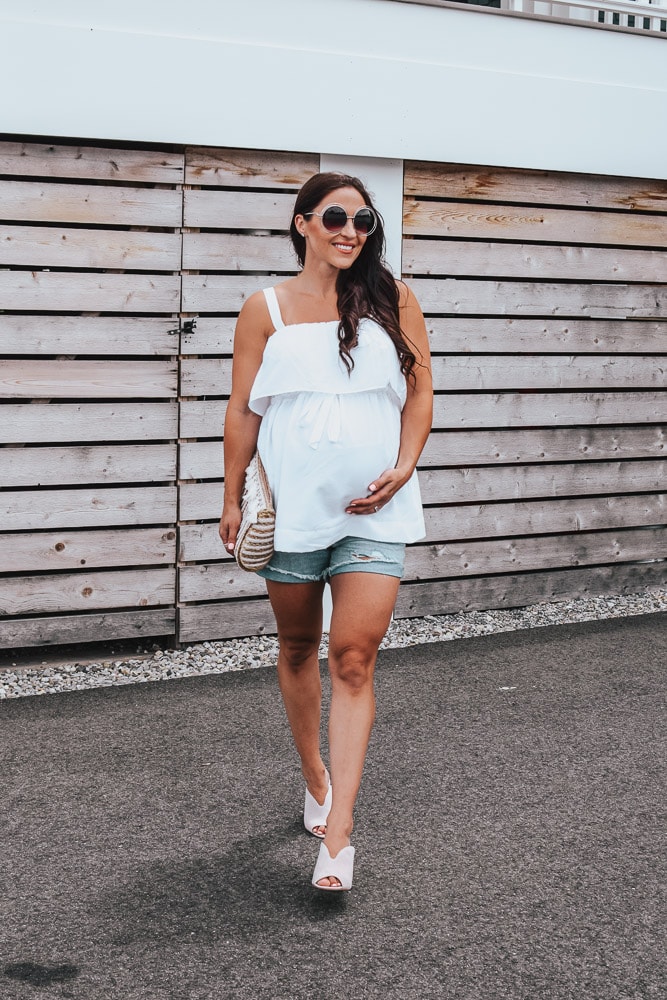pregnant woman in white babydoll tank top and mules