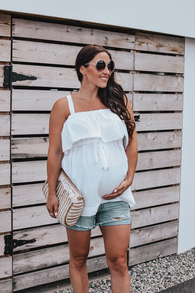 woman in white babydoll tank top and shorts - pregnancy outfits ideas