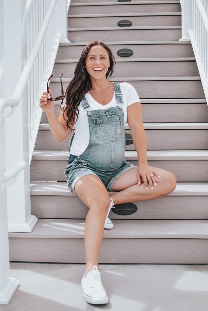 smiling woman in pregnancy overalls