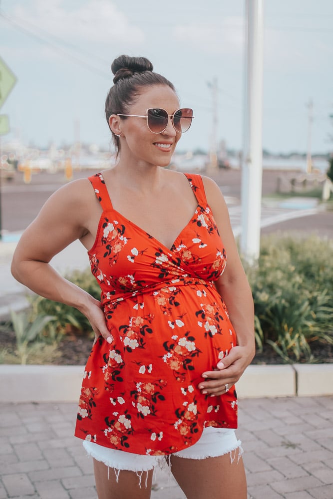 woman in floral blouse - pregnancy outfits ideas