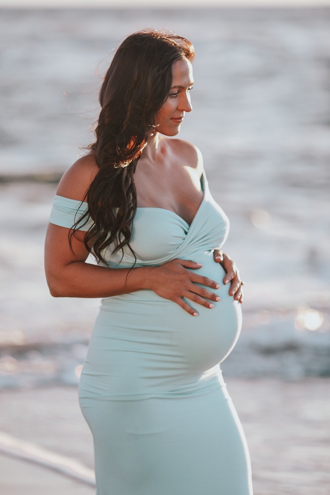 woman at a beach maternity photoshoot