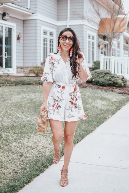 A woman wearing a floral romper. 