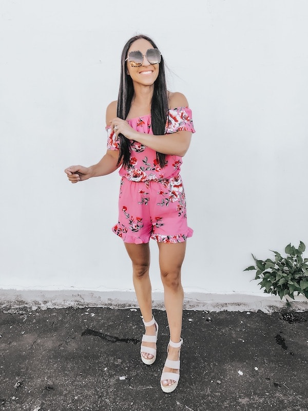woman wearing a pink floral romper