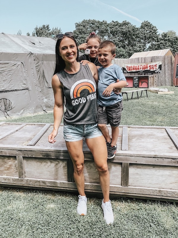 woman wearing a good vibes tank top holding her kids