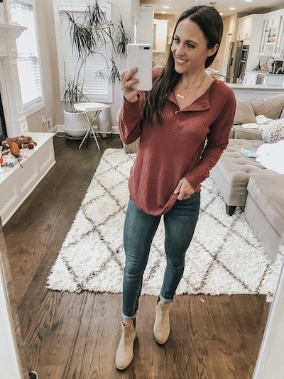 woman wearing a brown waffle knit top, jeans, and booties