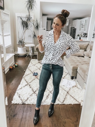 woman wearing a leopard button up, jeans, and black booties