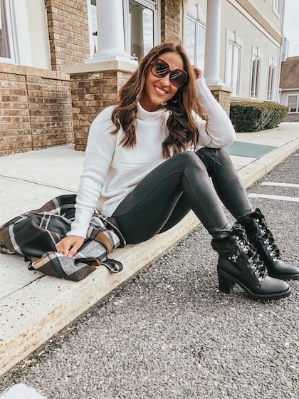 comfy outfits - woman wearing a white turtleneck, black leggings, and black boots
