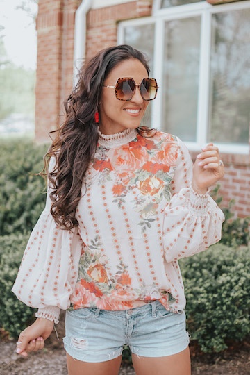 A woman in a floral blouse.
