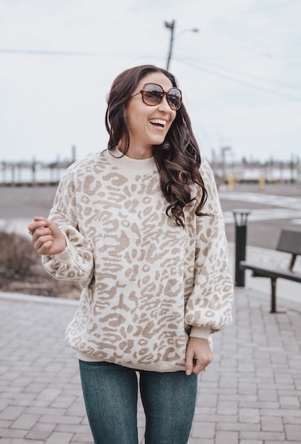 A woman wearing an oversized leopard sweater.