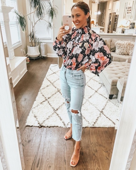 woman in floral blouse and jeans - cute fall outfits