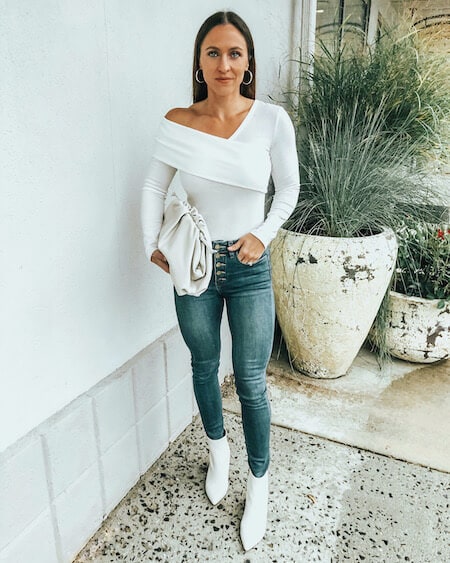 woman in white boots, jeans, and white sweater outfit