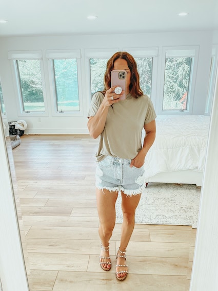 woman in distressed shorts - affordable brands at revolve