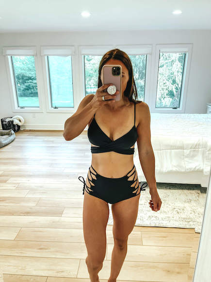 A woman wearing black strappy bikini.