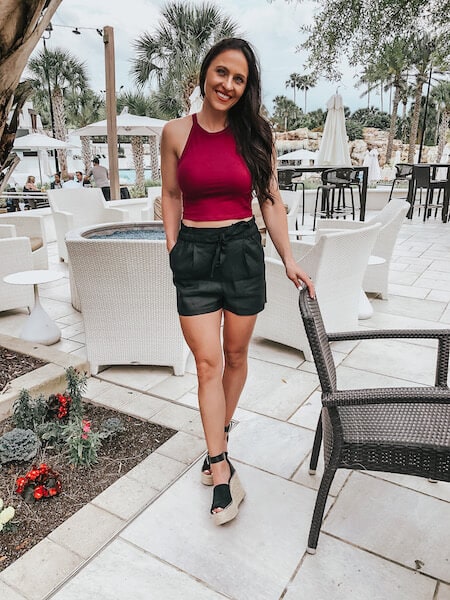 woman wearing black shorts and a crop top