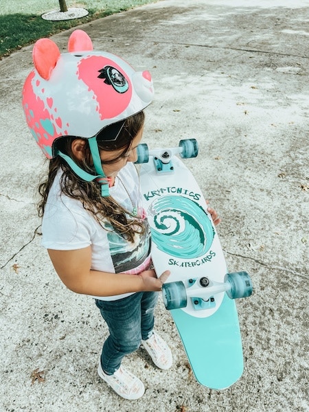 kid holding skateboard - best outdoor gifts for kids