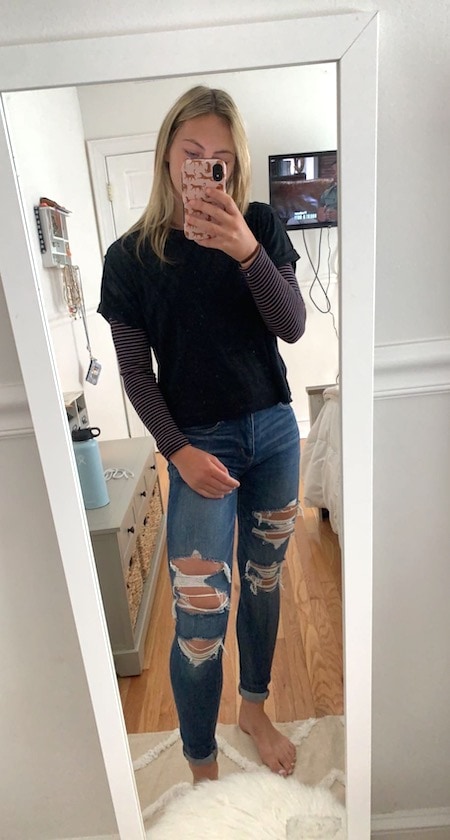 girl wearing black long sleeve top and jeans