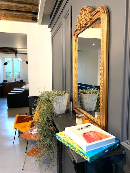 large brass mirror over a console table