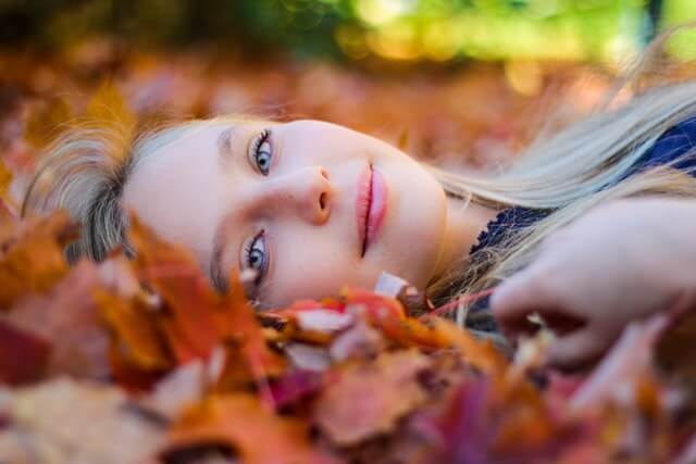woman laying in leaves