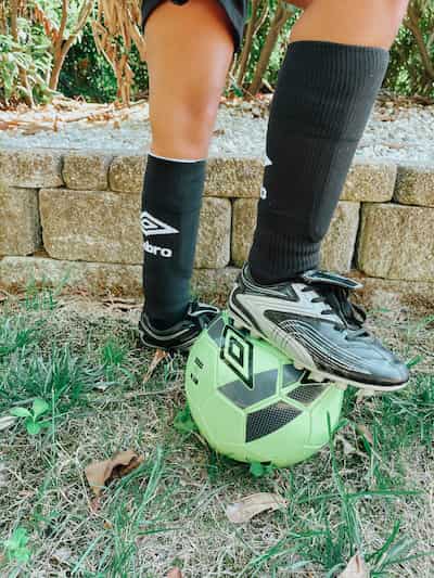 childs foot on a soccer ball