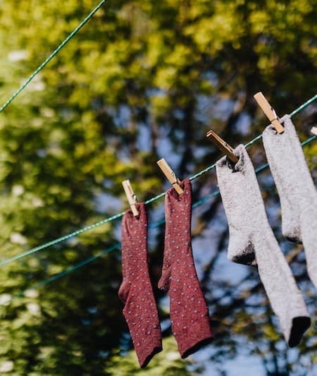 socks hang drying on a clothing line