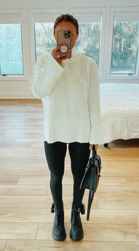 woman wearing black yoga pants and a cream sweater