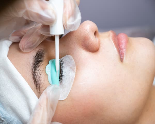 A woman getting a lash lift done on her eyelashes