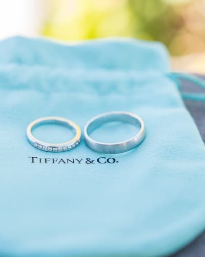 Tow silver Tiffany & Co rings on a blue Tiffany & Co bag