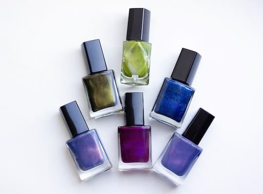 Holo nail polish in a variety of colors including purple, blue, and green