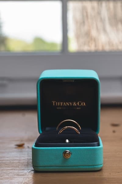 A blue tiffany & co box with women's gold rings inside.