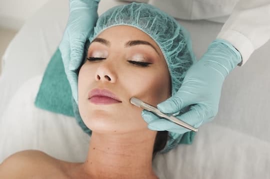 A woman having a microdermabrasion done on her face.