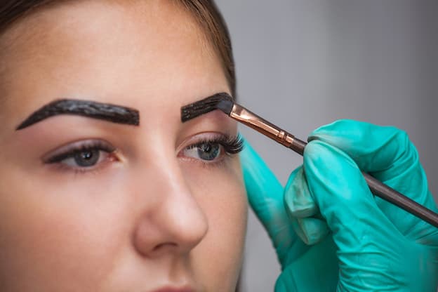 A woman having her eyebrows tinted.