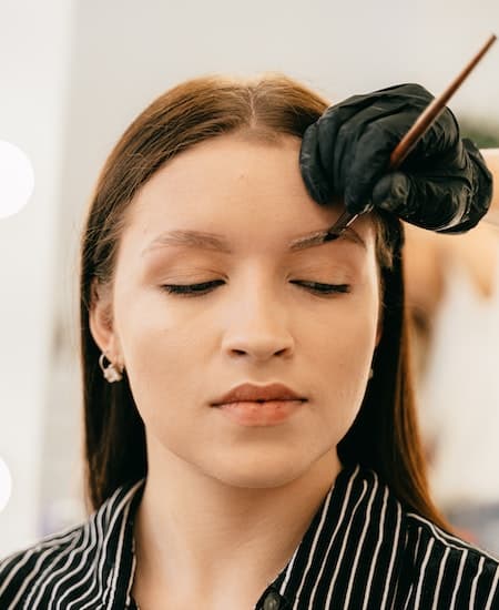 A woman having miroblading done on her eyebrows.