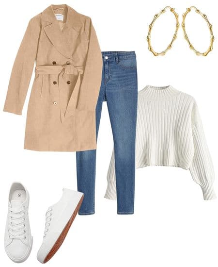 A woman's trench coat outfit idea featuring a tan trench coat, skinny jeans, white sneakers, a white sweater, and gold hoop earrings.