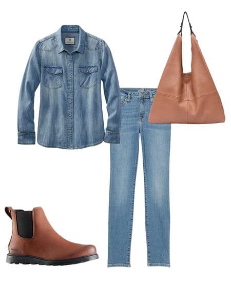Women's denim on denim outfit with skinny jeans, a denim button up shirt, brown ankle boots, and a brown hobo bag