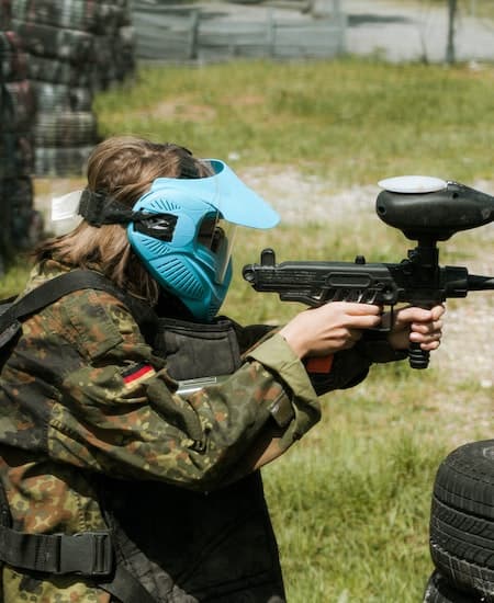 A woman playing paintball.