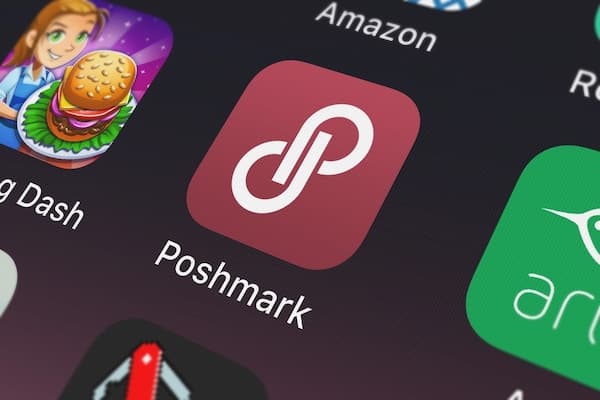 The Poshmark app icon on a cell phone.