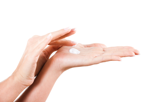 A woman with lotion on her hand.