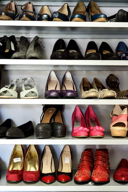 A variety of women's shoes on shelves.