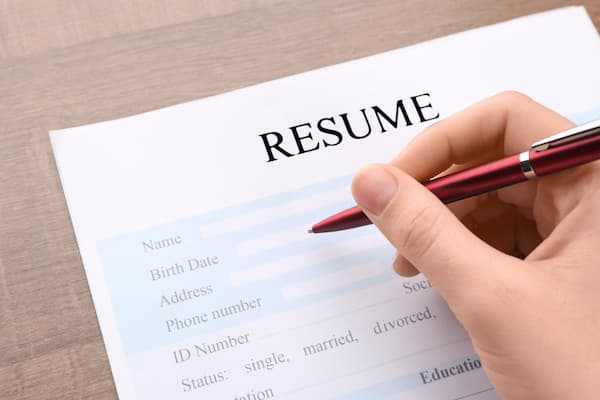 A woman filling out a resume.
