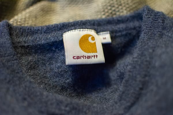 A carhartt label inside of a blue shirt.