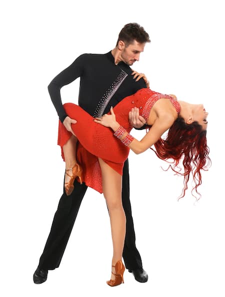 A man and woman salsa dancing.