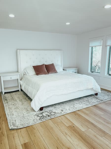 A white tufted upholstered bed from Pottery Barn.