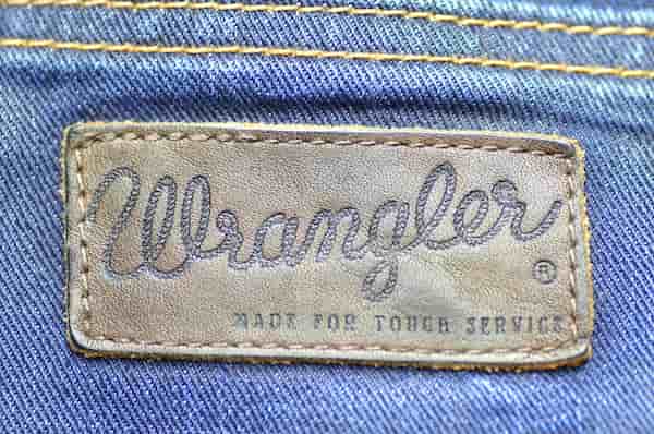 A Wrangler logo on the back of a pair of jeans.