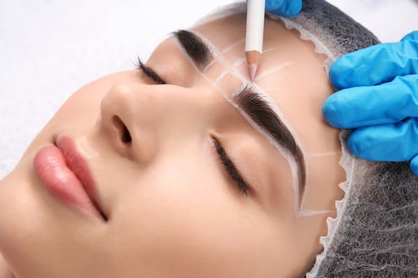 A woman getting ready for a combination brows procedure.