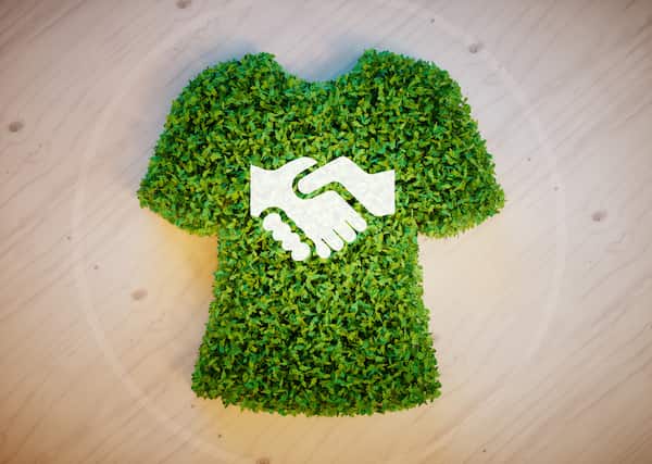 an eco-fashion concept displayed by a handshake on a leaf shirt