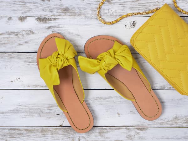 A pair of womens yellow slides.