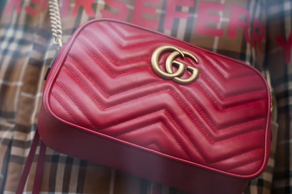  A red Gucci handbag with the double g logo. 