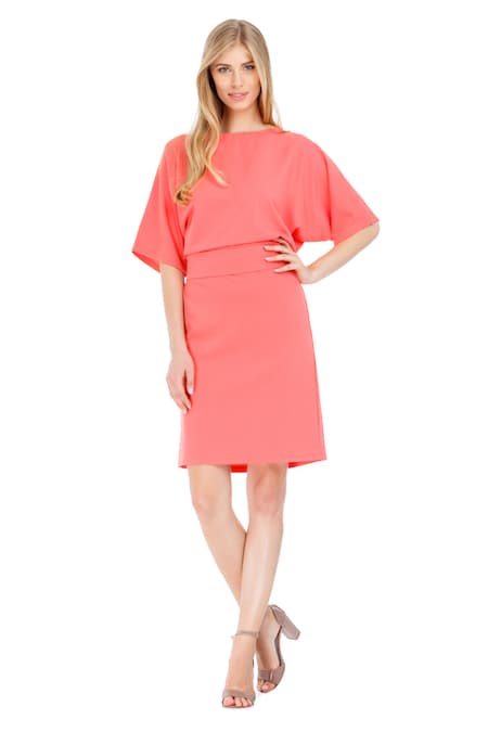 A woman wearing a pink midi dress