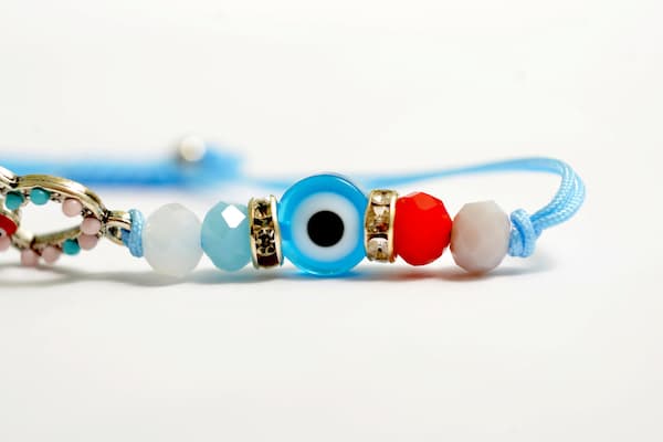 A light blue evil eye bracelet.