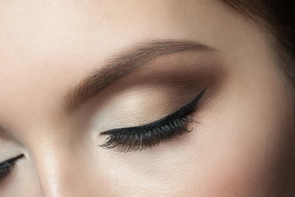 A woman's eye with permanent eyeliner.